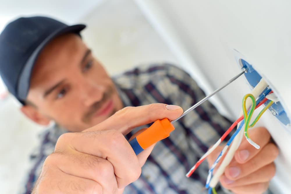 Man wiring a light switch